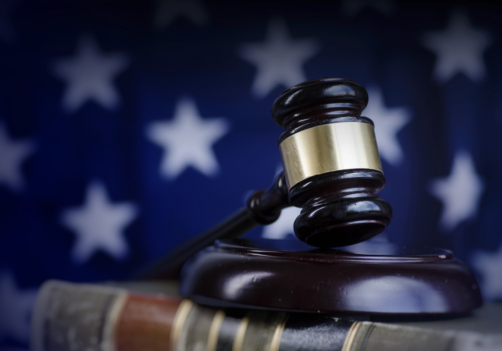 A stock photo of a gavel in front of the American flag.